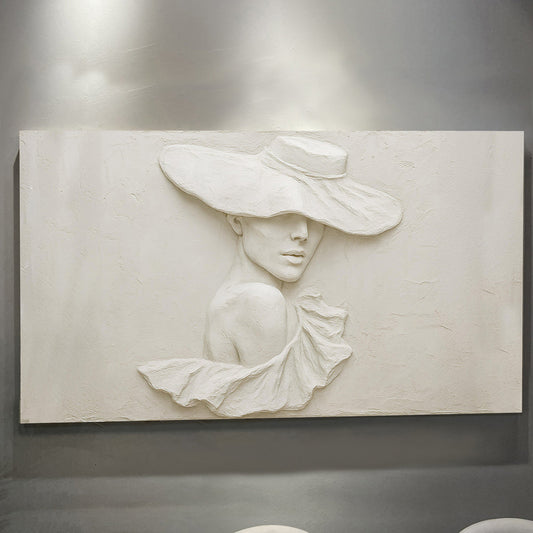 Close-up of the sculptural female portrait with hat in cream tones
