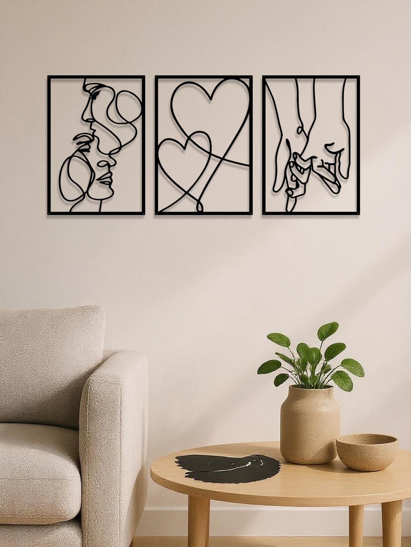 Couples line art wall decor above a side table with minimalist styling