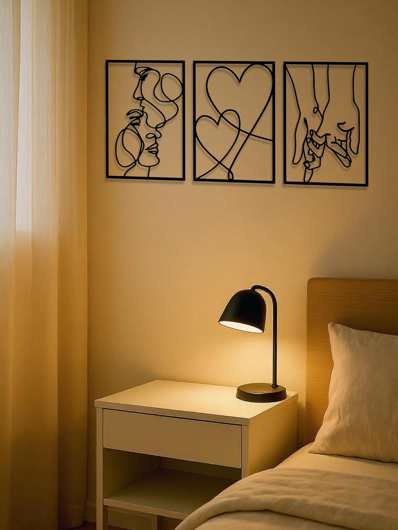 Romantic line art metal set hanging above a warm bedside lamp