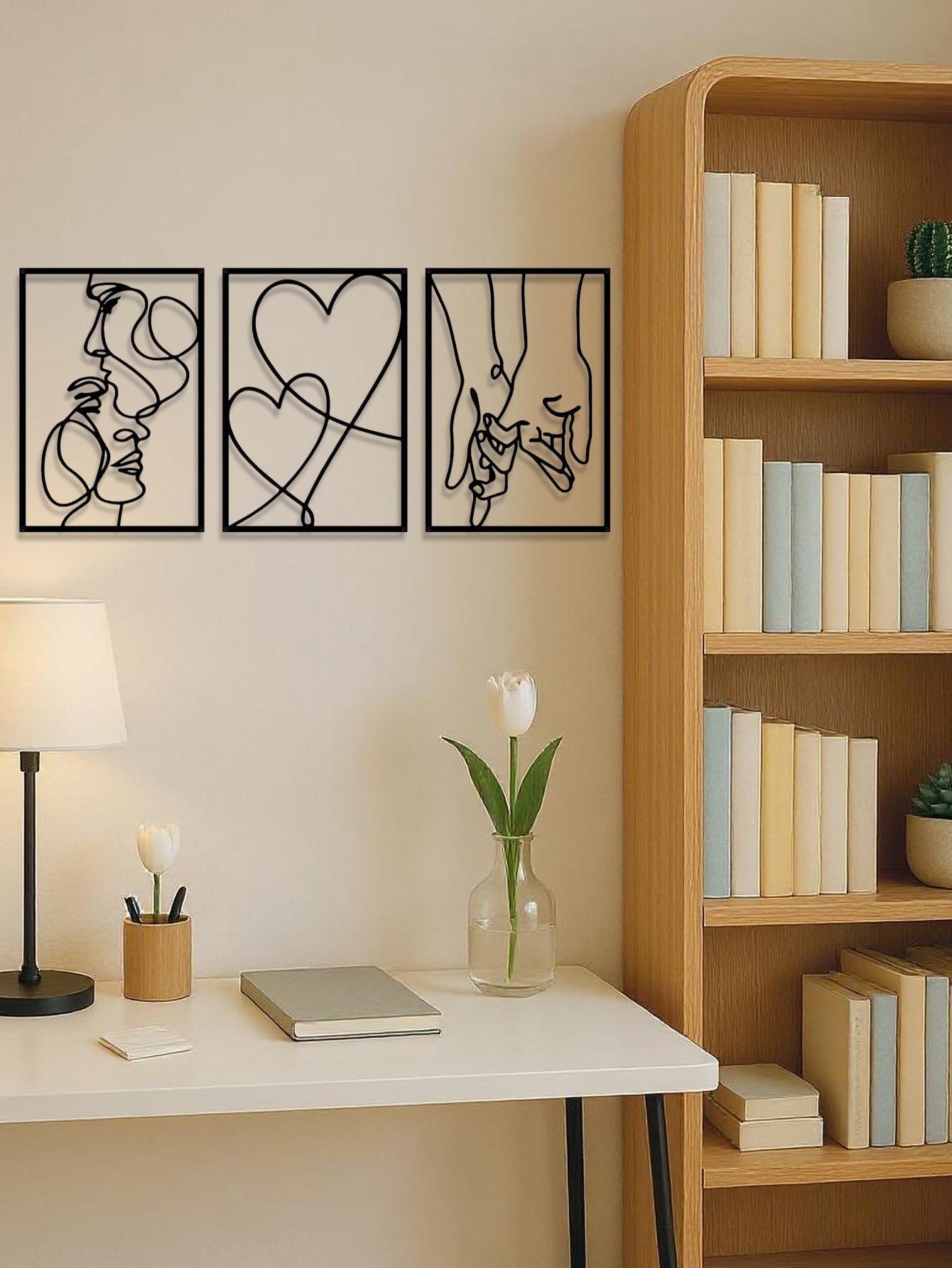 Black metal couples wall art in a minimalist home office with bookshelf