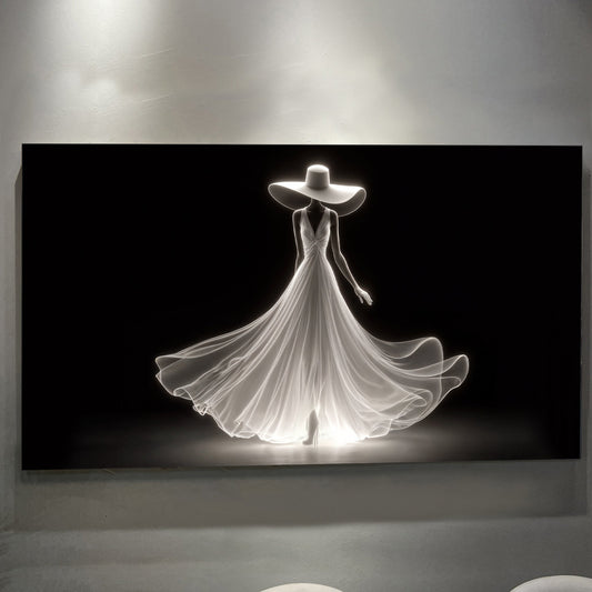 Luminous white silhouette of a woman in a wide-brim hat and flowing gown on black canvas wall art