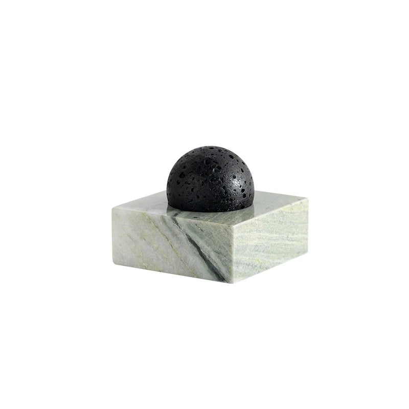 Marble diffuser detail with a small green leaf accent