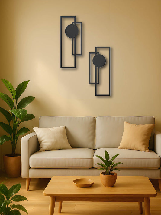 Sculptural metal wall pieces in a minimalist living room with plants